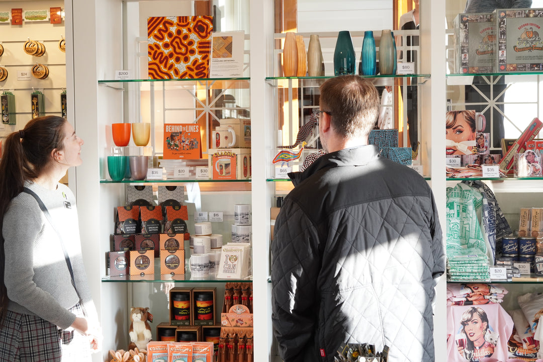 Two customers browse products in a shop.