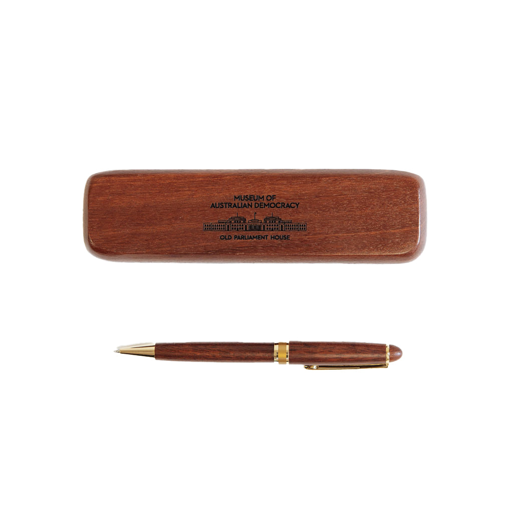 A wooden pen alongside a wooden box featuring an image of Old Parliament House. 