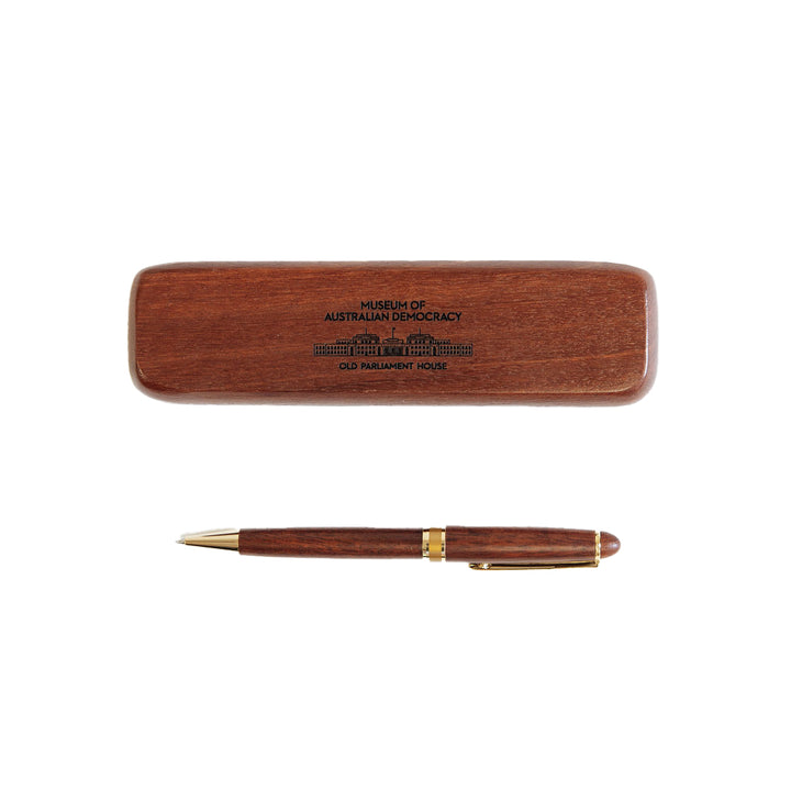 A wooden pen alongside a wooden box featuring an image of Old Parliament House. 